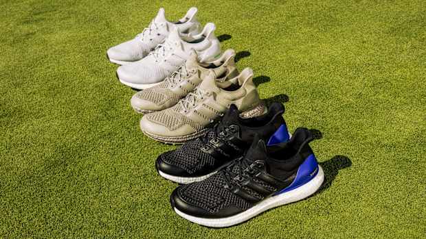 Side view of multicolor adidas golf shoes.